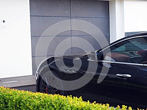 Black Car Parked in Driveway