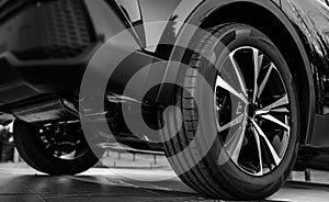 black Car in showroom. Aluminum wheel with Tire. automobile wheel tire. aluminium rims. Motor Corporation is Japanese automotive