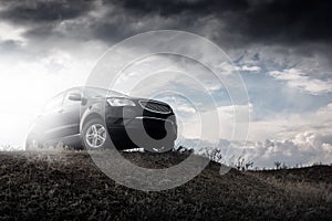 Black car stay on hill in dramatic clouds at daytime photo