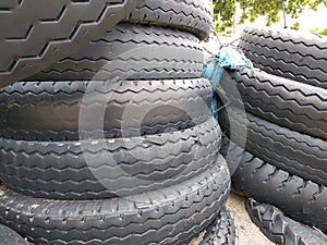 Black car tires piled on the beach