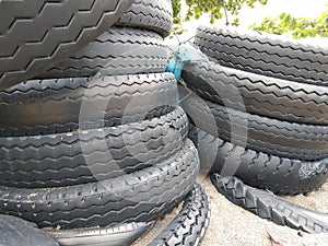 Black car tires piled on the beach