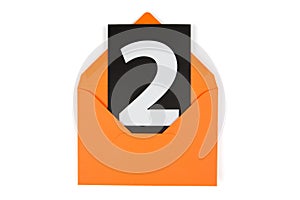 black card with a white number two in an orange paper envelope