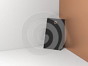 Black cardboard tag label Mockup leaned against the golden wall