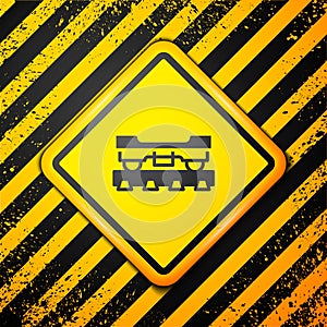 Black Cargo train wagon icon isolated on yellow background. Freight car. Railroad transportation. Warning sign. Vector