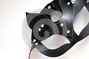 Black carnival cat style mask made of leather with rhinestones on white background
