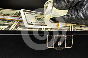 Black case full of dollar bills close up.Money bricks in case