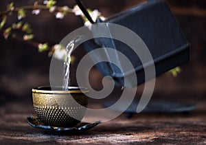 Black cast iron kettle and a cup