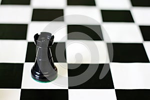 Black castle on chess board