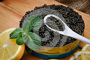 Black caviar in a bowl on the table