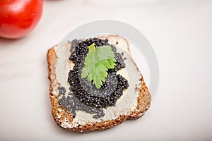 Black caviar on a slice of bread