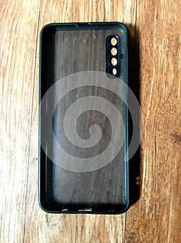 black cell phone security on a brown background