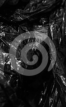 Black cellophane bag. Close up. Background. Texture