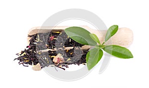 Black ceylon tea with rose petals, cornflowers and sunflower, isolated on white background.