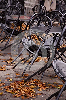 Black chairs propped against tables.