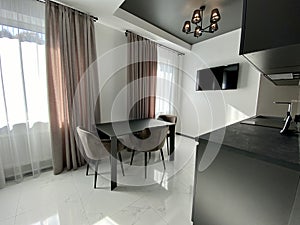 Black chairs and a table with a TV in the dining room