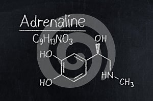 Black chalkboard with the chemical formula of Adrenaline