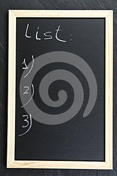 Black chalkboard with wooden frame.