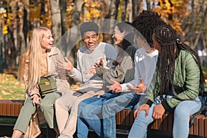 Black cheerful guy telling friends funny story photo