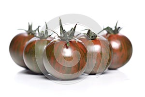 Black cherry tomatoes on white background