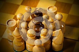 Black Chess King Surrounded by White Pieces