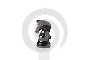Black chess knight on a table
