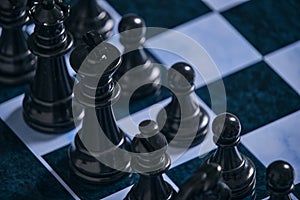 Black chess pieces on a chessboard