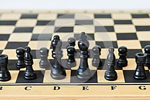 Black chess pieces or figures on game chessboard