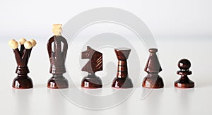 Black chess pieces in a row