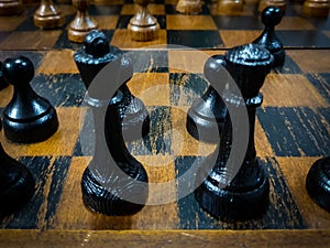 black chess pieces in starting formation close-up