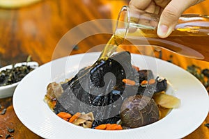 Black chicken Soup on wood dish