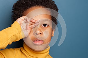 Black child boy crying. Unhappy African American kid face