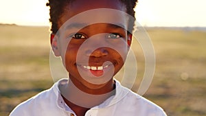 Black child, boy and face at sunset in nature park, Congo garden or sustainability environment on school trip. Portrait