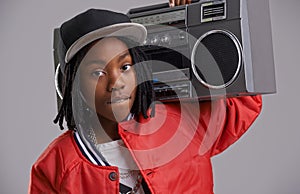 Black child, confidence and portrait with radio for hip hop, rap and swag dance with cool clothes in studio. Youth, teen