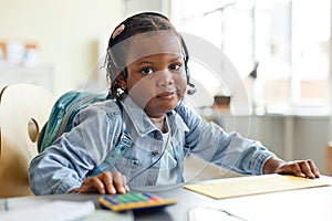 Black child playing home office work with calculator