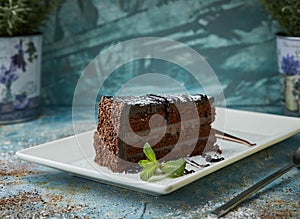 Black chocolate cake on a white plate