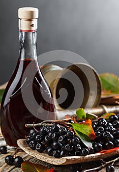 Black chokeberry and bottle with juice .