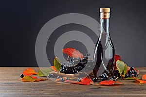 Black chokeberry and bottle with juice .