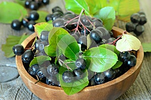 Black chokeberry in brown bowl