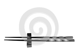 Black chopsticks on an elevated rest isolated