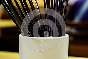 Black chopsticks in a jar