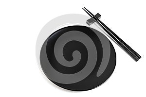 Black chopsticks and black plate on white