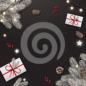 Black Christmas background with silver fir branches, gift boxes, pine cones, garland of stars. Xmas and New Year theme