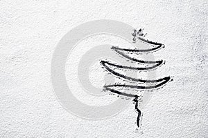 Black Christmas tree on snowy flour background. Top view