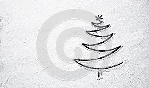 Black Christmas tree on snowy flour background. Top view