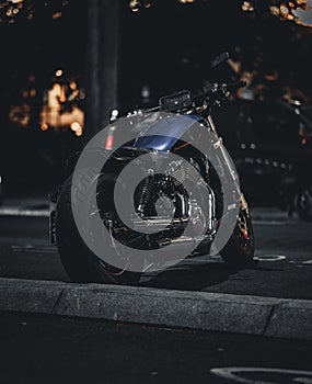 Black and chrome motorcycle parked on a city street at night