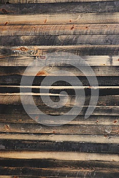 Black circular saw pattern on pine wood slats, wide view