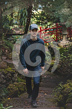 Black-clad adventurer walks through the Monte Palace Madeira botanical garden in Funchal, the capital of the Portuguese island.