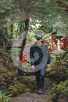 Black-clad adventurer walks through the Monte Palace Madeira botanical garden in Funchal, the capital of the Portuguese island.