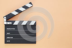 Black clapperboard isolated on color background, flat lay