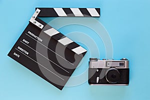 Black clapperboard isolated on color background, flat lay